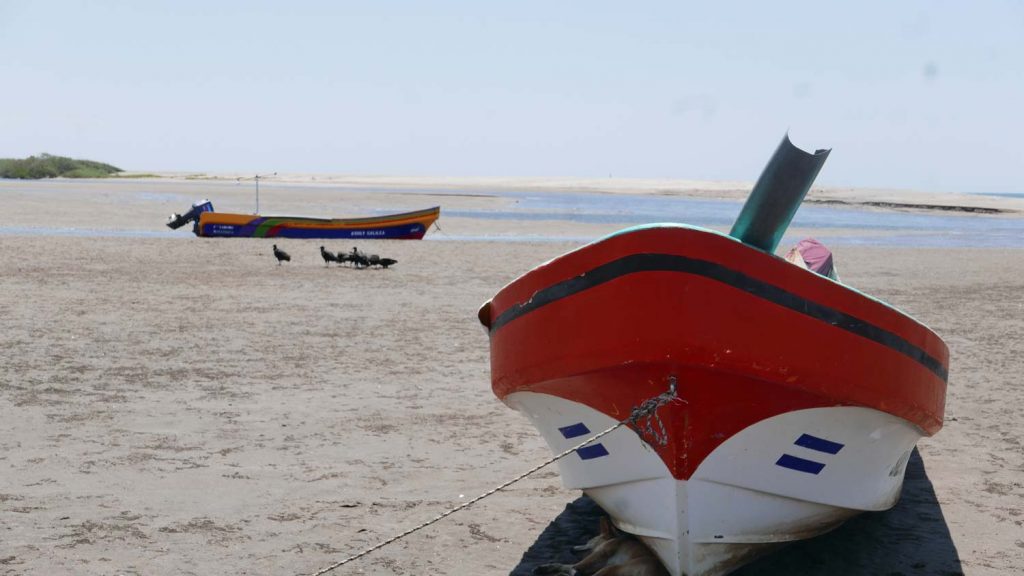 Boats during low tide on Las Penitas beach, near Leon in Nicaragua