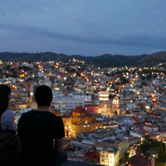 Couple overlooking the city centre of Guanajuato by night