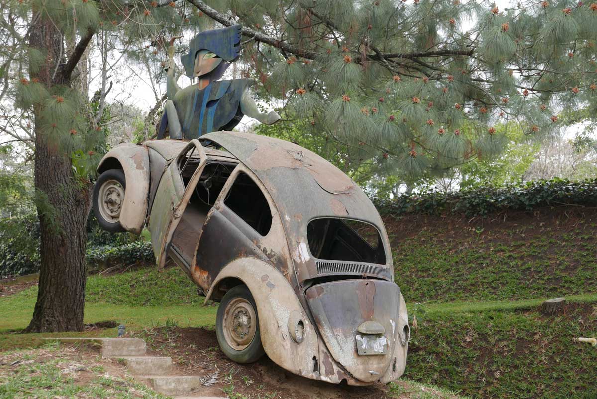 Crashed Volkswagen Beetle as a sculpture at Santo Domingo de Cerros near Antigua