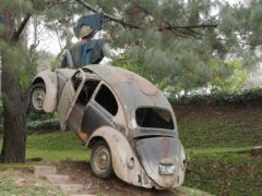 Crashed Volkswagen Beetle as a sculpture at Santo Domingo de Cerros near Antigua